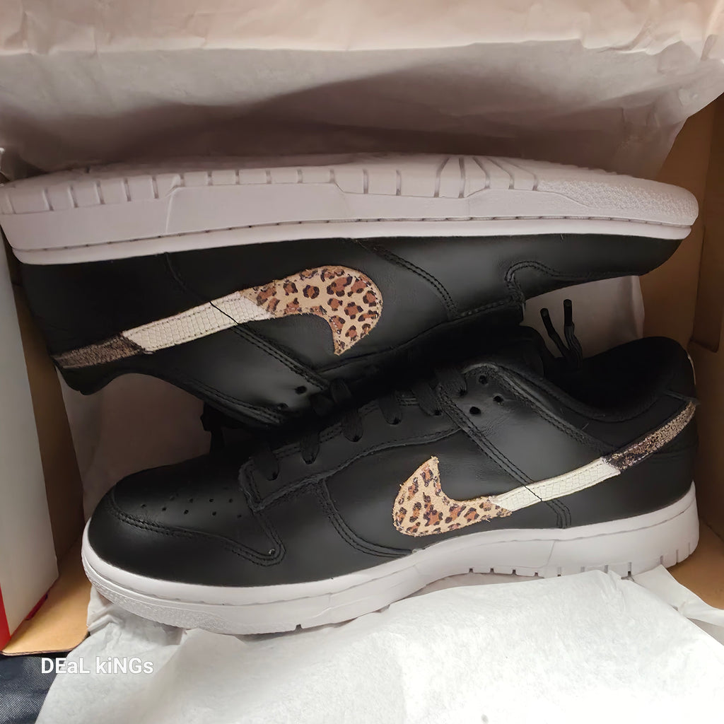 Nike Women's Dunk Low SE Primal sneakers feature a black leather upper with a distinctive animal print Swoosh.