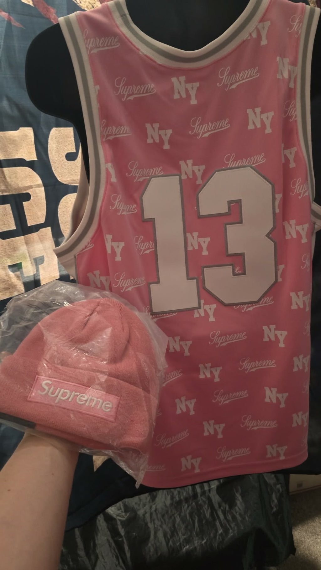Pink Supreme x Mitchell & Ness monogram basketball jersey features tackle twill appliqué and a matching woven logo label at the lower front.Release Date: May 07, 2026