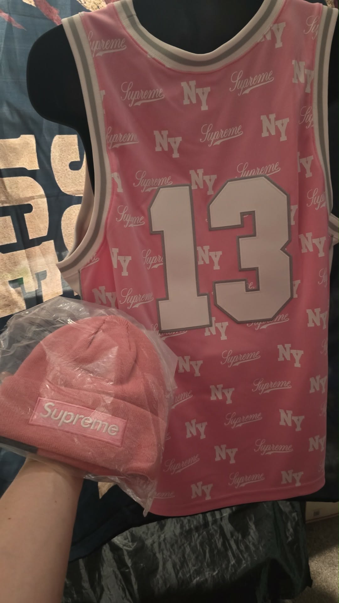 Pink Supreme x Mitchell & Ness monogram basketball jersey features tackle twill appliqué and a matching woven logo label at the lower front.Release Date: May 07, 2026