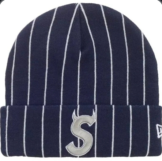 Supreme New Era Devil S Logo Beanie 'Stripe' from the Spring/Summer 2026 collection. It features a navy pinstripe acrylic knit design with an embroidered "S" logo detailed with devil horns.