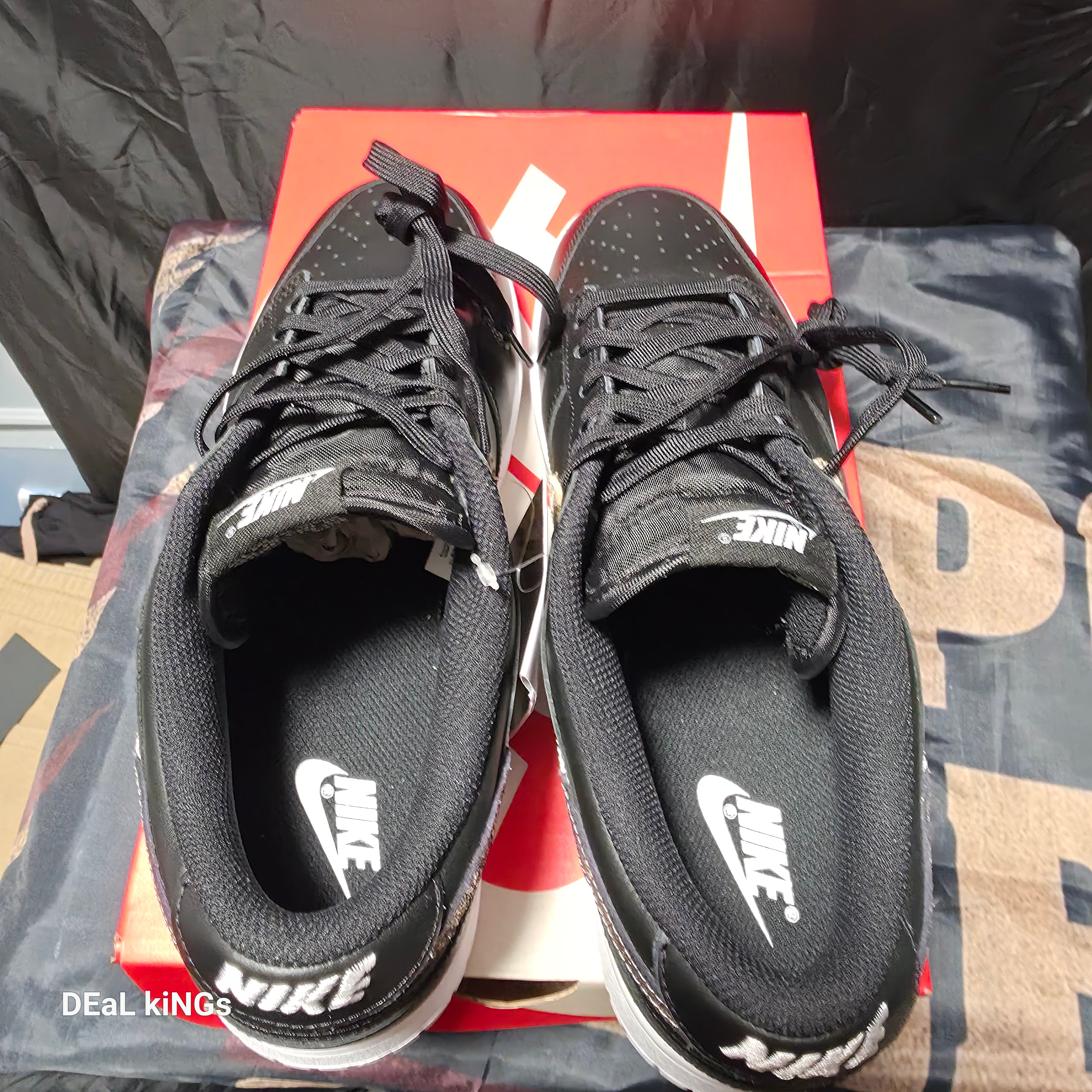 Nike Women's Dunk Low SE Primal sneakers feature a black leather upper with a distinctive animal print Swoosh.