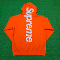 Supreme Satin Appliqué Hooded Sweatshirt in Bright Orange, featuring a large white satin logo running vertically down the back.