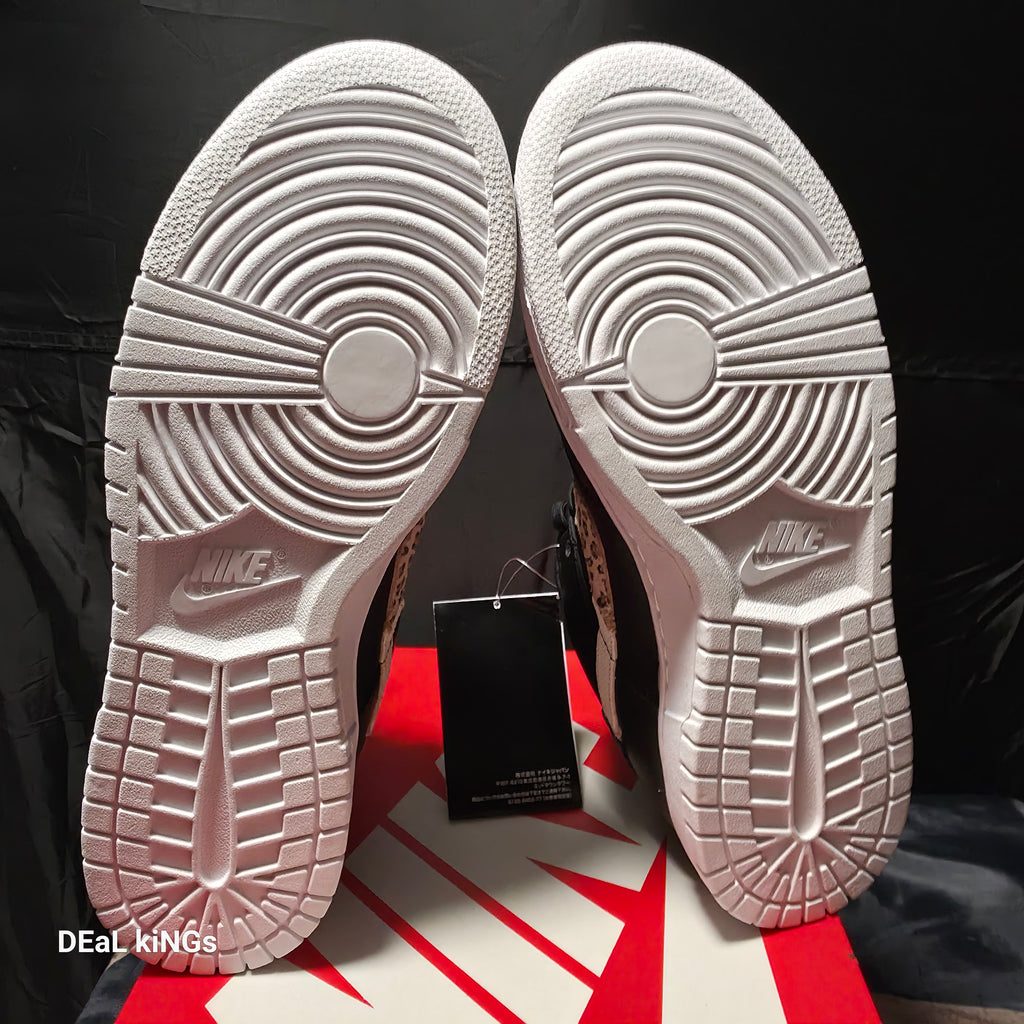 Nike Women's Dunk Low SE Primal sneakers feature a black leather upper with a distinctive animal print Swoosh.